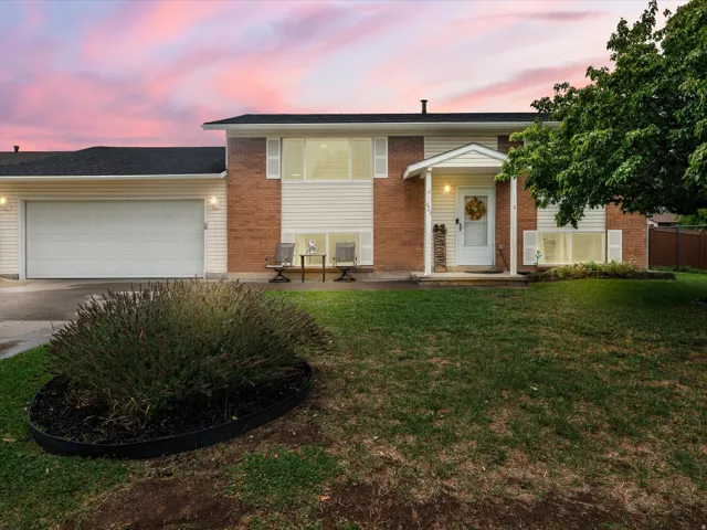 Brick and siding exterior featuring a two-car garage