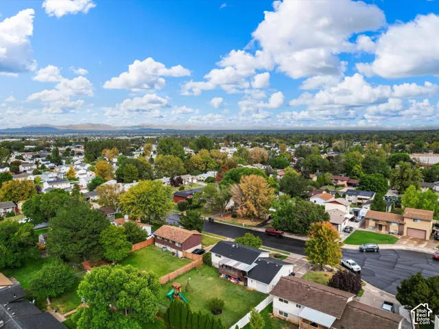 Expansive neighborhood setting with established homes, mature trees, and mountainous scenery