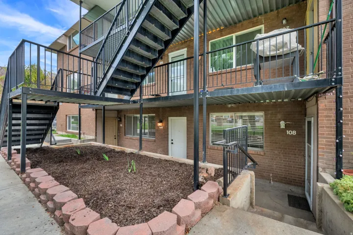 Brick exterior with black metal railings and exterior staircases
