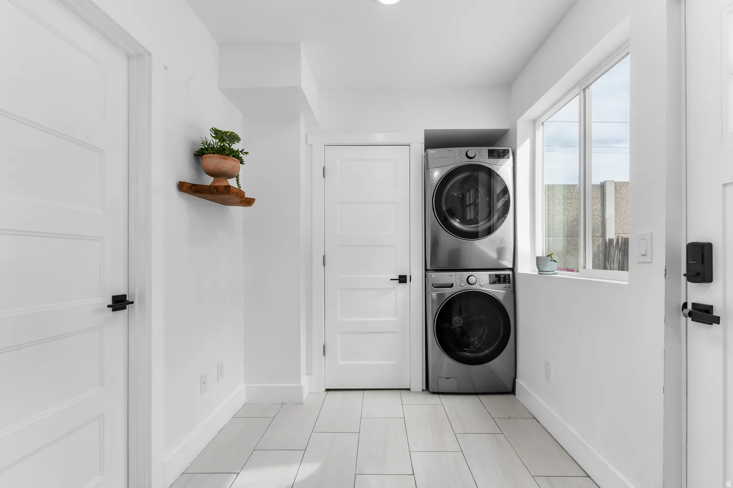 Guest house entry with closet and laundry equipment