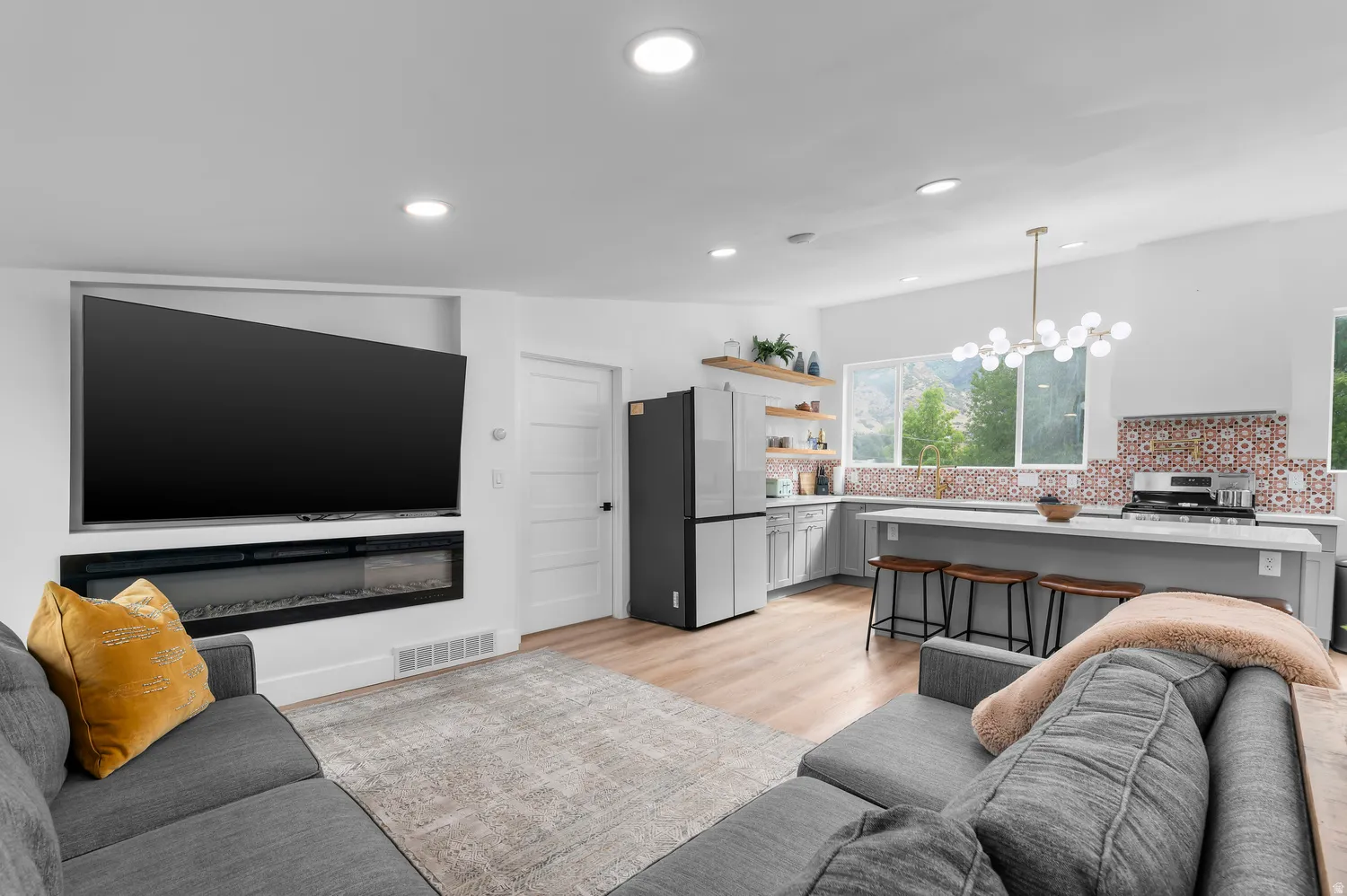 Spacious living area featuring a built-in electric fireplace and recessed lighting