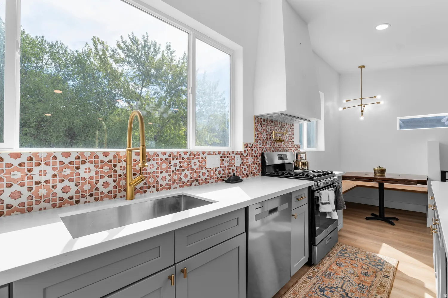 Guest house kitchen featurin gas stove, pot filler, and mountain views
