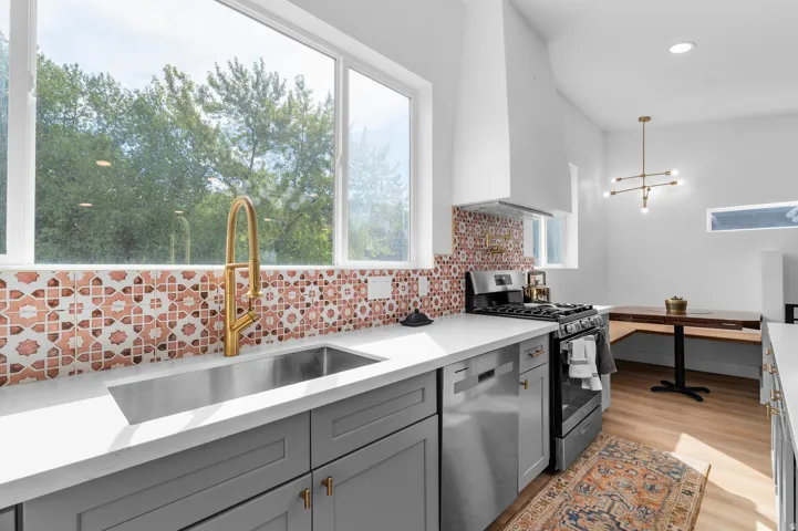 Guest house kitchen featurin gas stove, pot filler, and mountain views