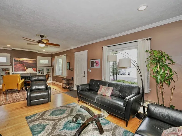 Hardwood flooring, recessed lighting, crown molding, ceiling fan, and white trim