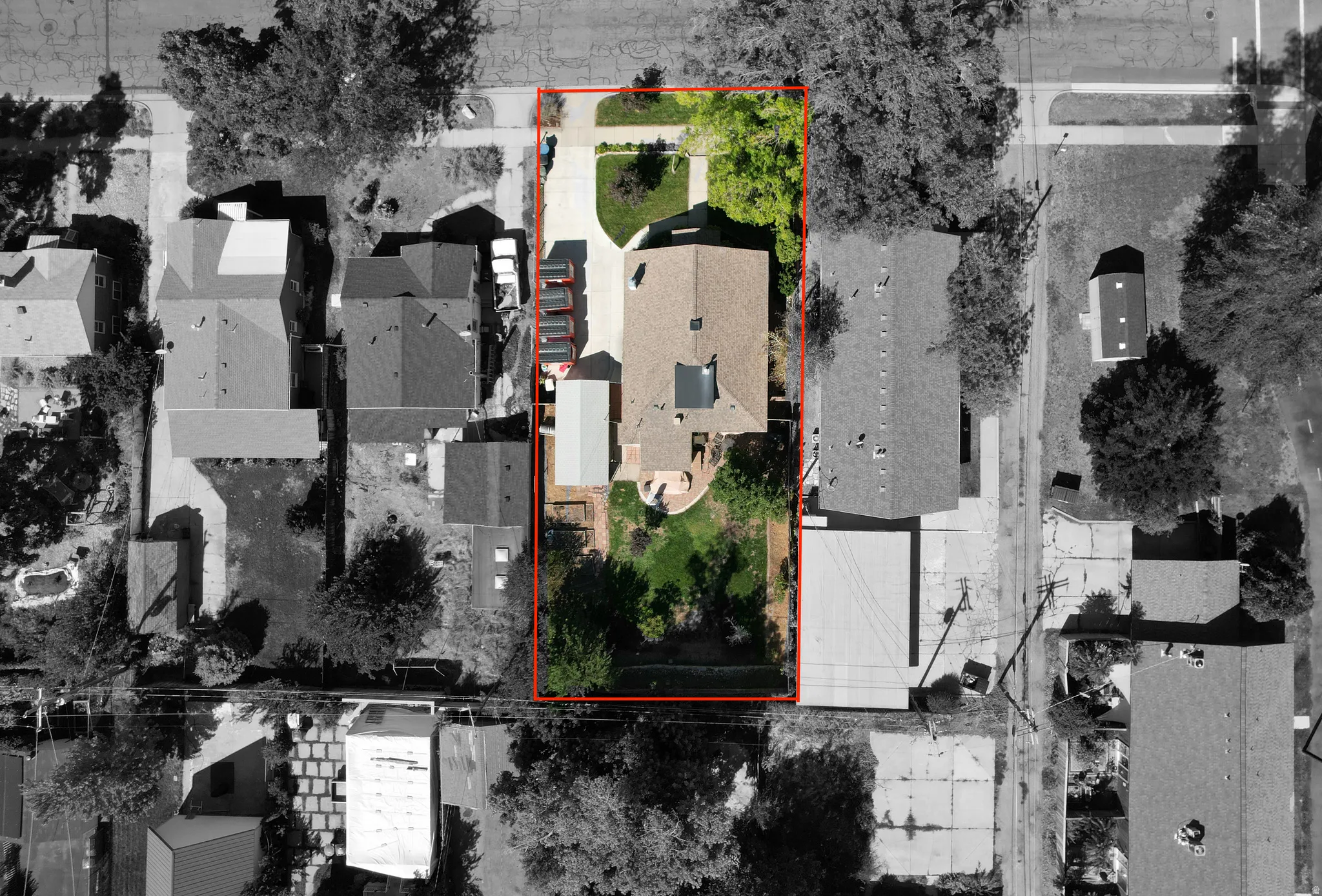 Expansive lot featuring a main residence, detached garage, and a large front yard
