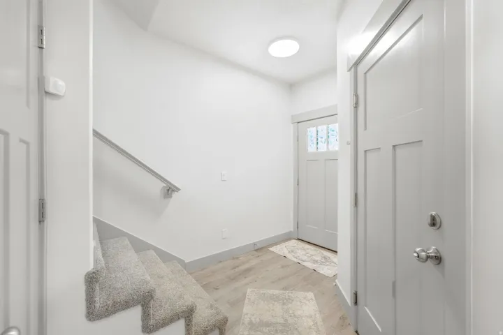 Light wood-finish flooring with a flush-mount ceiling light