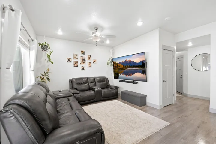 Recessed lighting, ceiling fan, wood-finish flooring, white walls, and light gray trim