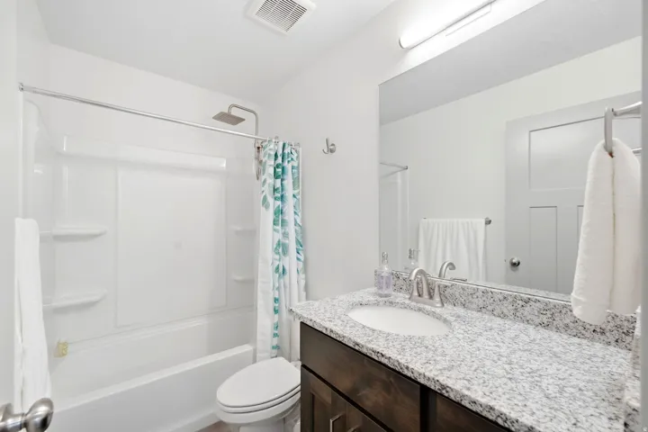 Vanity with a granite-style countertop and undermount sink