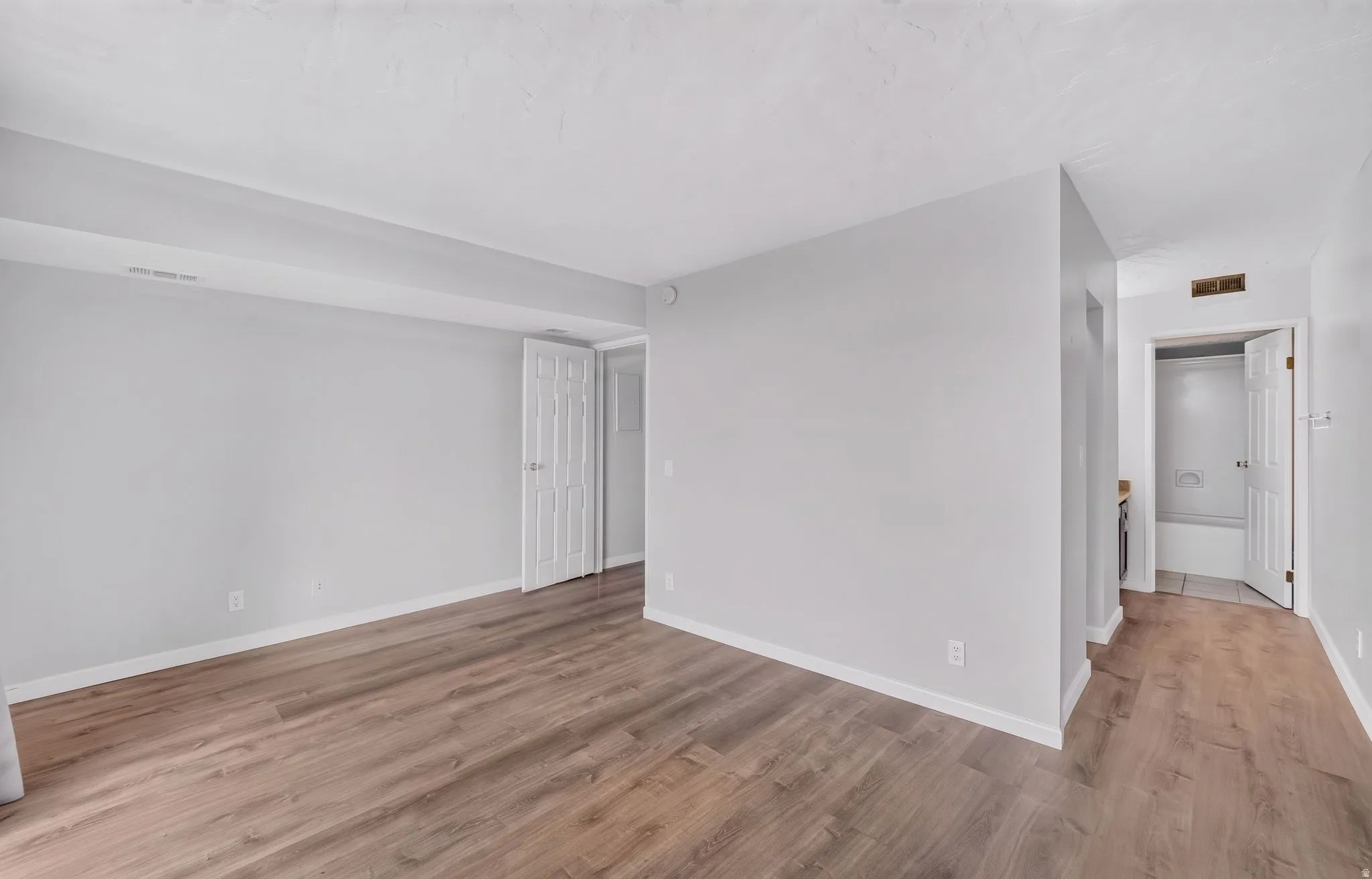 Wood-finish flooring and light gray wall tones