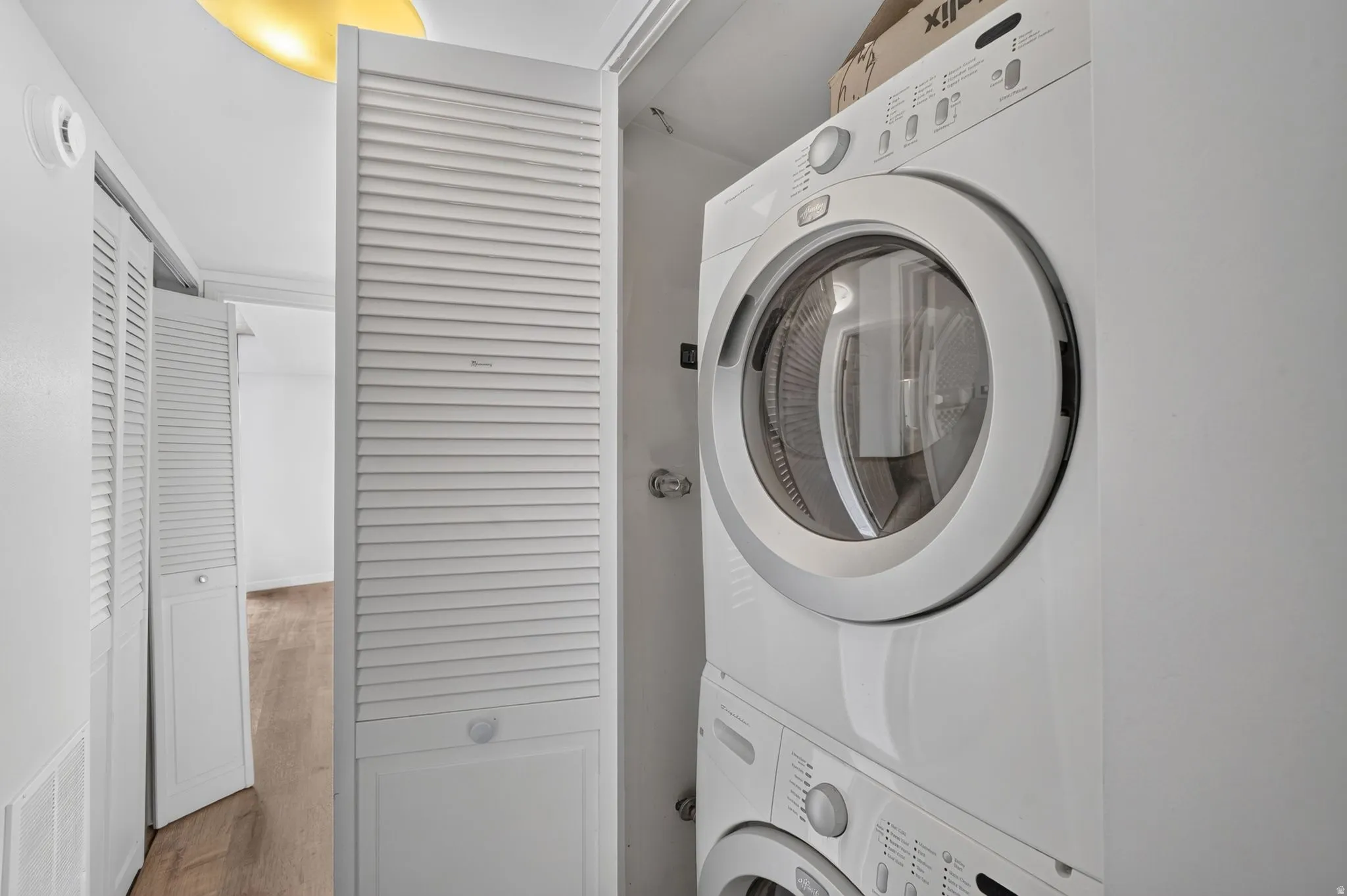 Stackable washer and dryer unit within a louvered closet