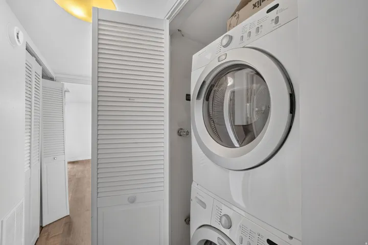Stackable washer and dryer unit within a louvered closet