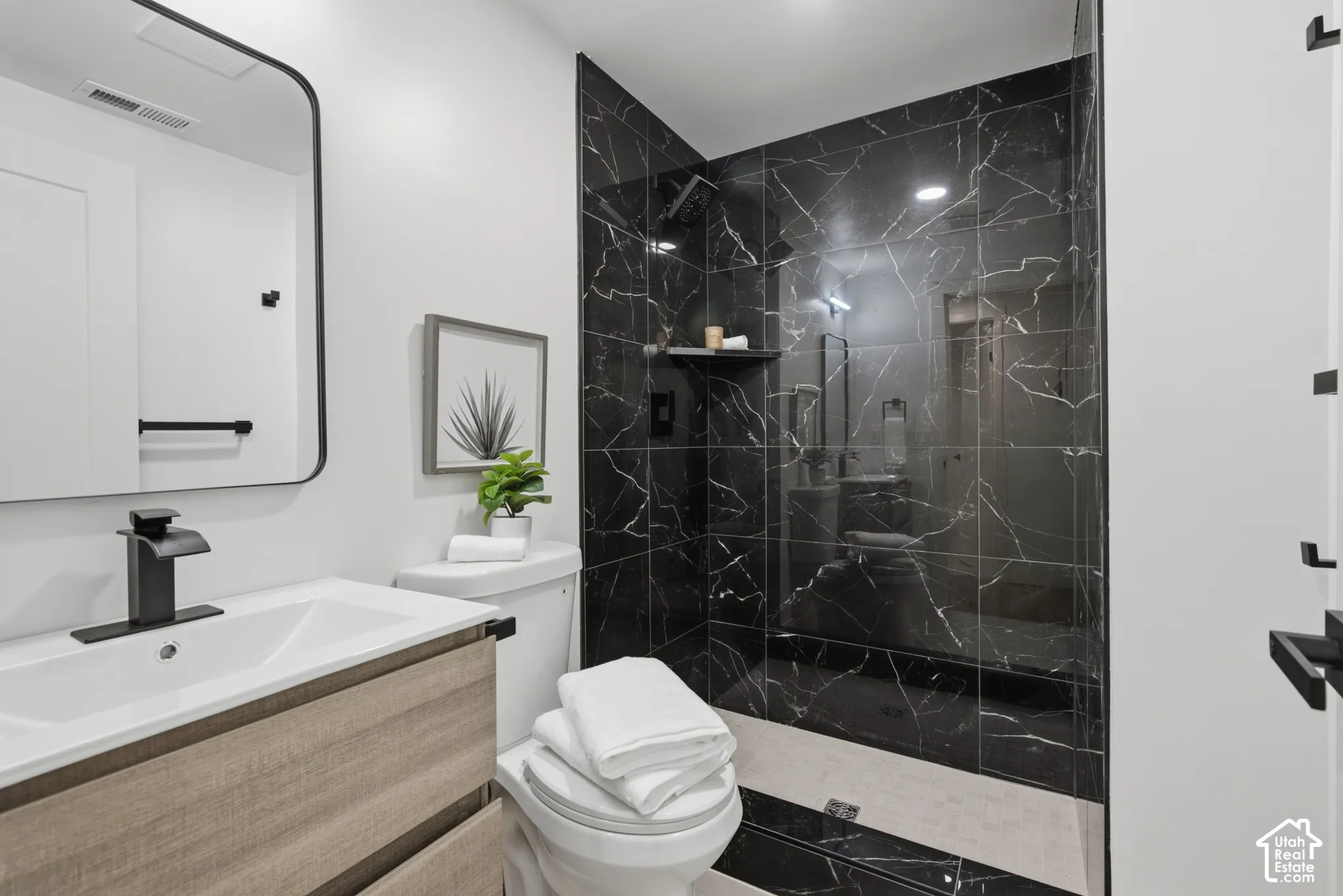 Modern vanity with integrated rectangular sink and matte black faucet