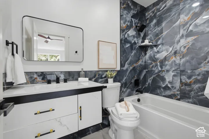 Floating vanity with gold-tone hardware and white countertop