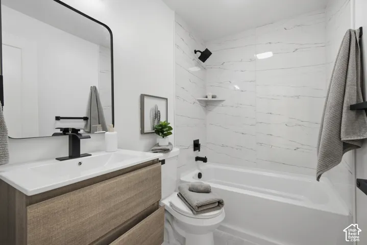 Floating wood-finish vanity with an integrated sink, matte black faucet, and large rectangular mirror