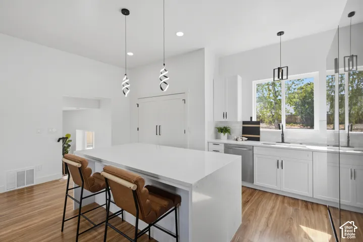 Modern kitchen with white cabinetry and a large center island