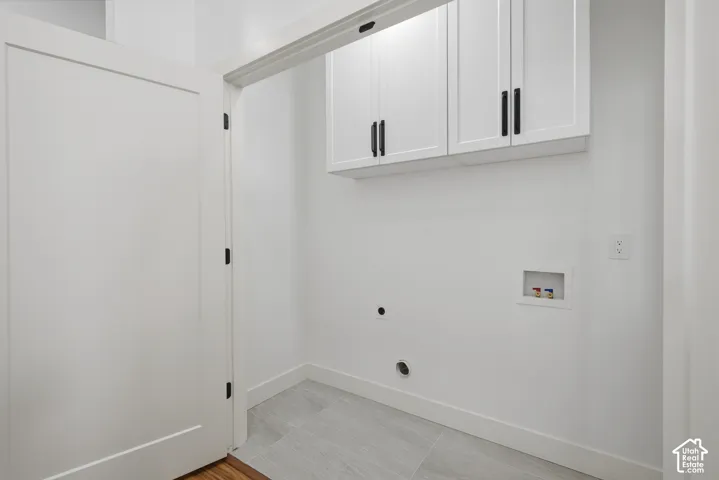 White shaker-style cabinetry with matte black hardware