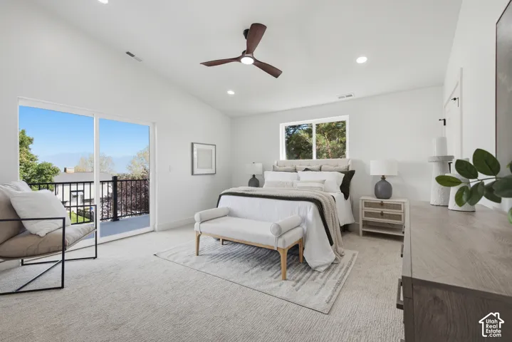 Vaulted ceilings with recessed lighting, ceiling fan, and a sliding glass door opening to a private balcony with black metal railings