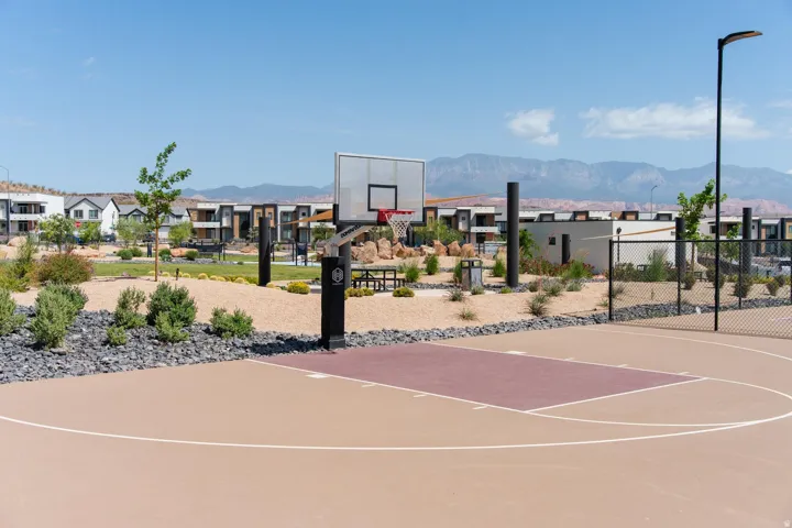 Outdoor basketball court featuring a clear backboard and painted lines