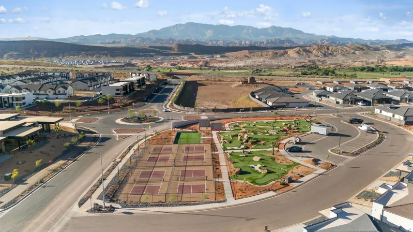 Community features include multiple pickleball courts, a manicured putting green, and mature landscaping