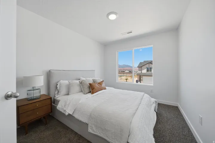 Recessed lighting, light-colored walls, large window, and carpeted flooring