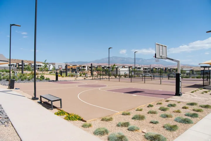 Multi-sport court with basketball hoops and perimeter fencing