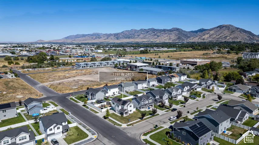 Expansive undeveloped lot situated within an established residential neighborhood, featuring paved streets and surrounding developed properties