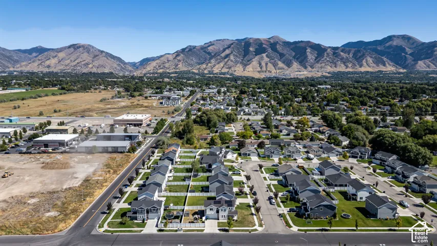 Residential community with mountain backdrop, developed streets, and uniform housing