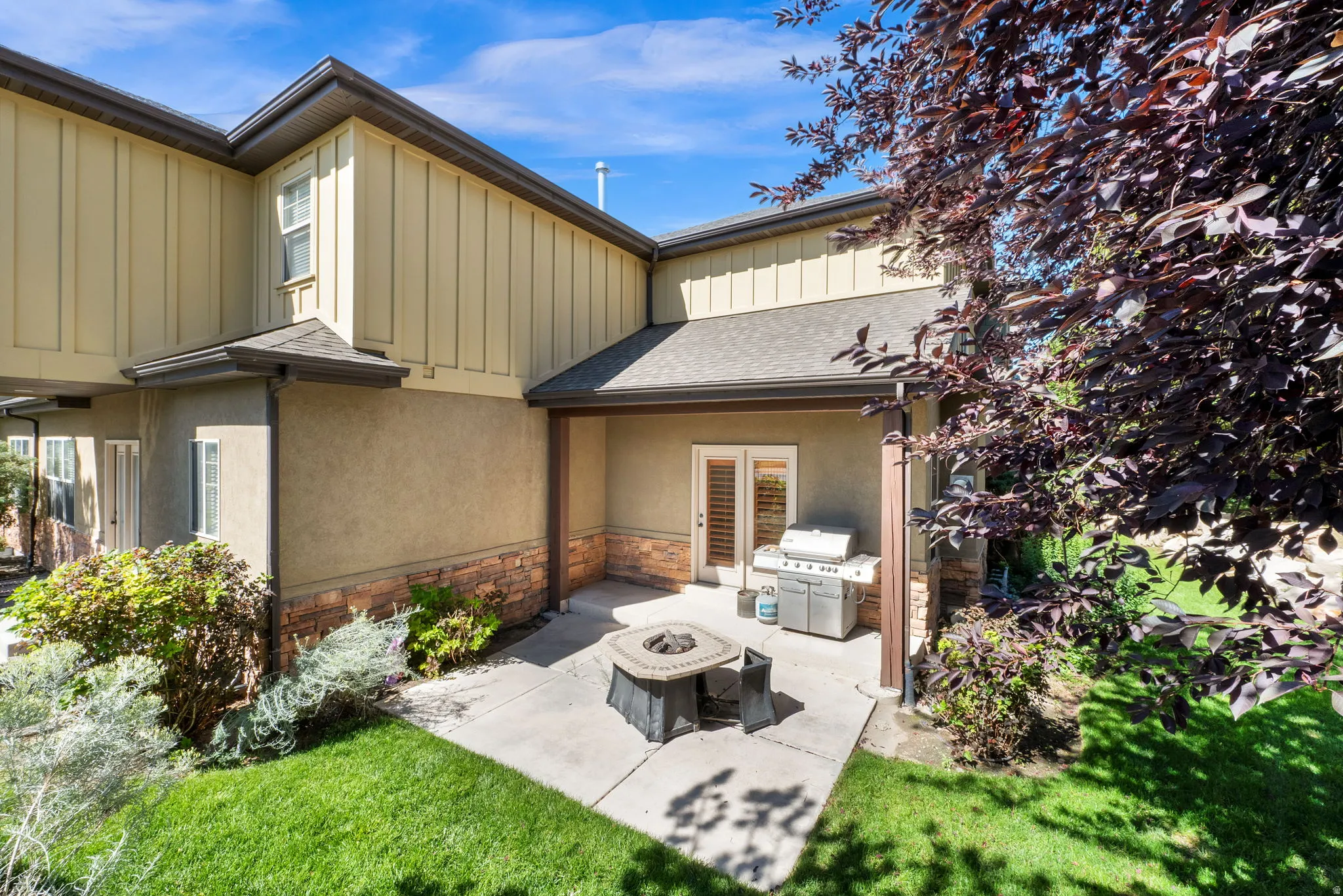 Covered patio featuring a concrete surface and a built-in fire pit