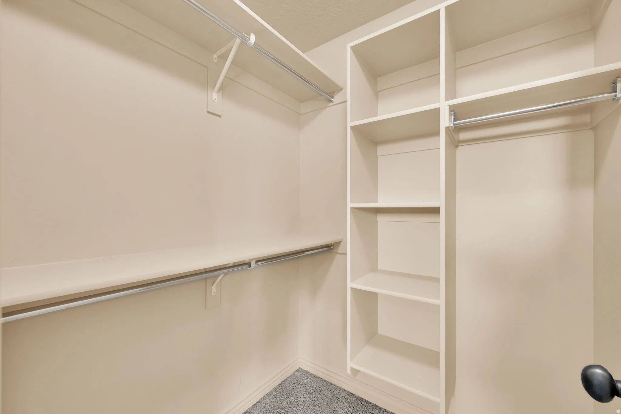 Built-in shelving, multiple hanging rods, and an integrated shelf system