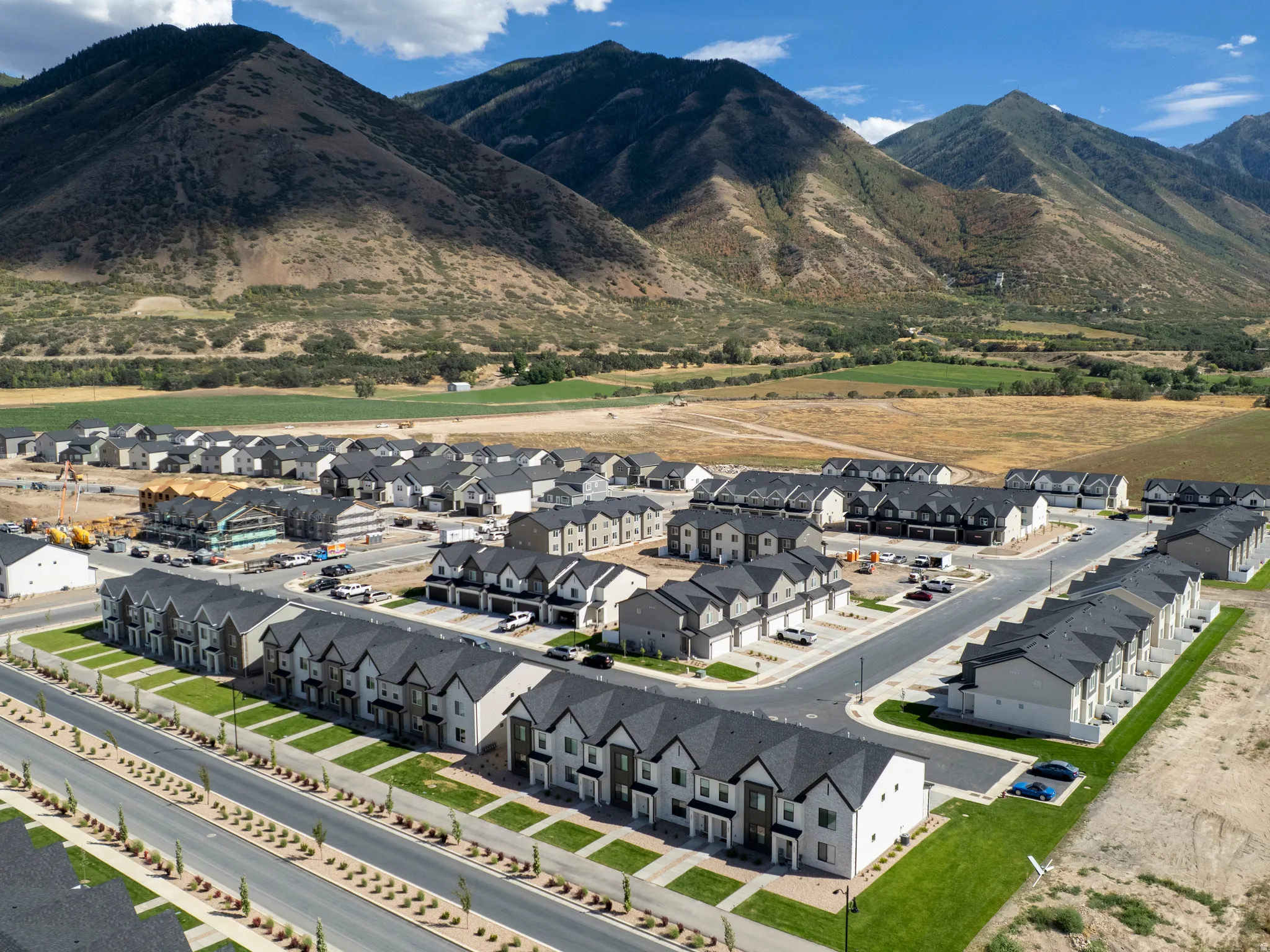 New construction development featuring a residential community with asphalt streets and landscaping