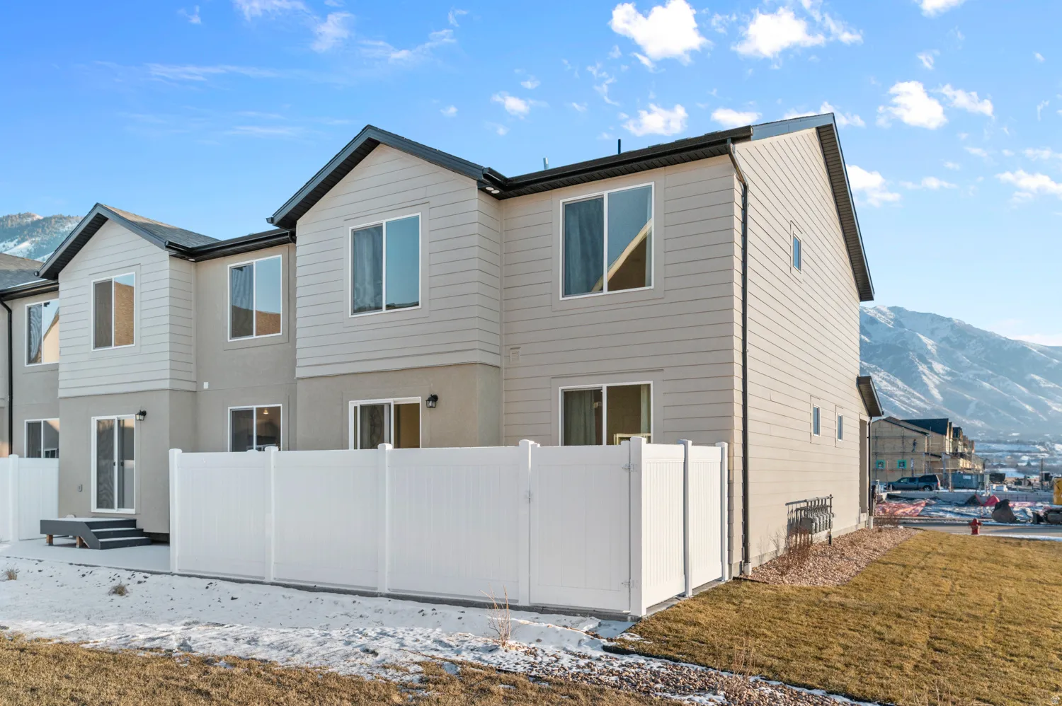 Contemporary exterior with light-colored siding and dark trim