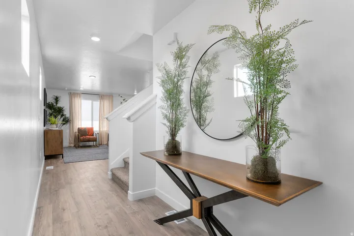 Entryway featuring wood-finish flooring, white walls, and recessed lighting
