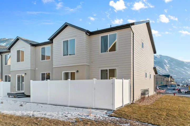 Contemporary exterior with light-colored siding and dark trim