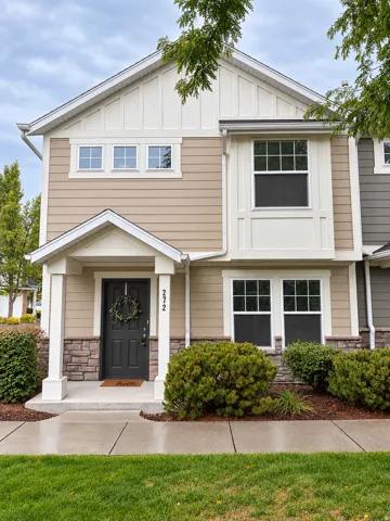 Multi-level facade with board and batten siding, horizontal siding, and stone accents