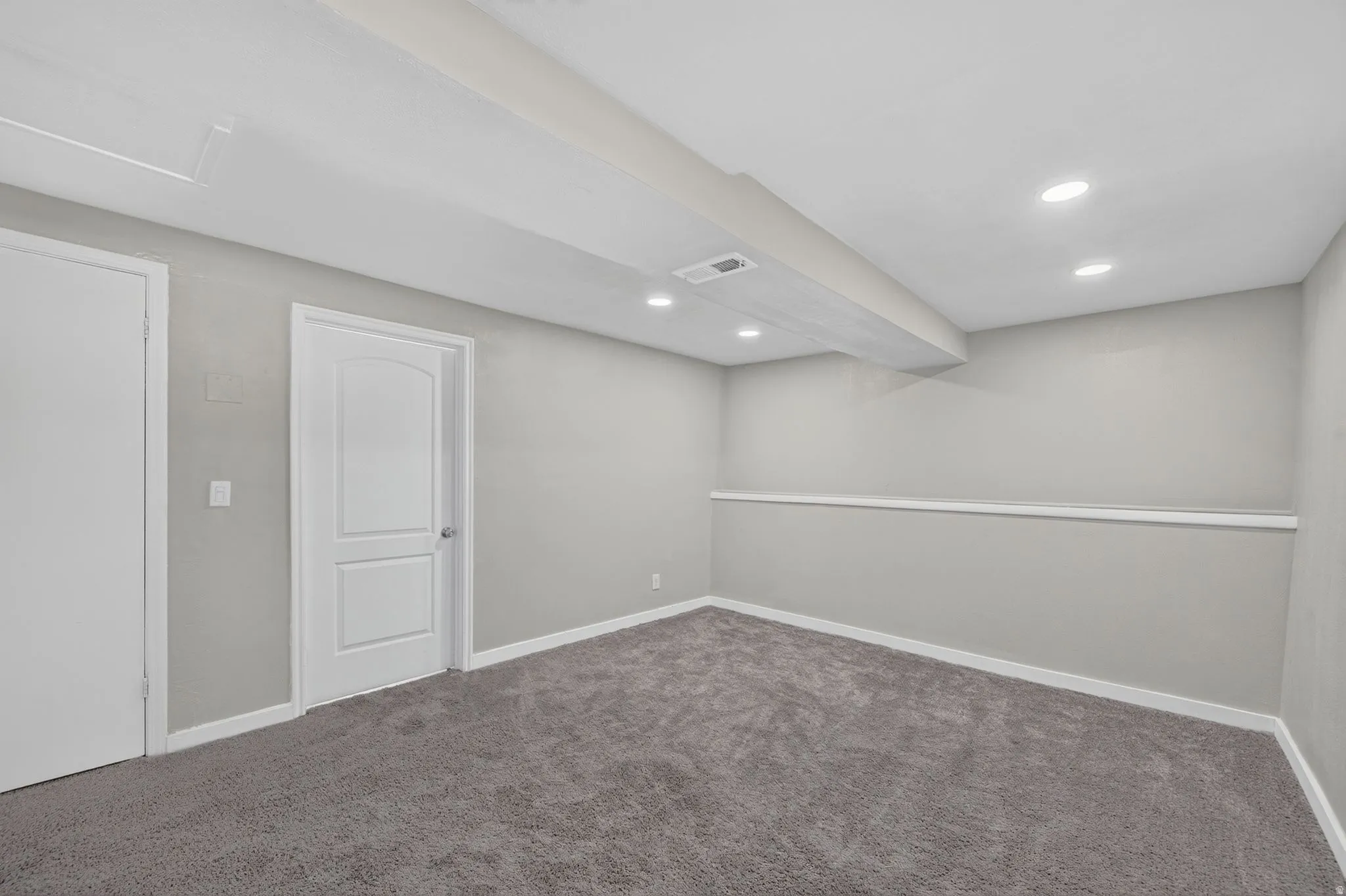 Recessed ceiling lighting, light gray wall paint, gray carpet flooring, white trim, and white paneled doors