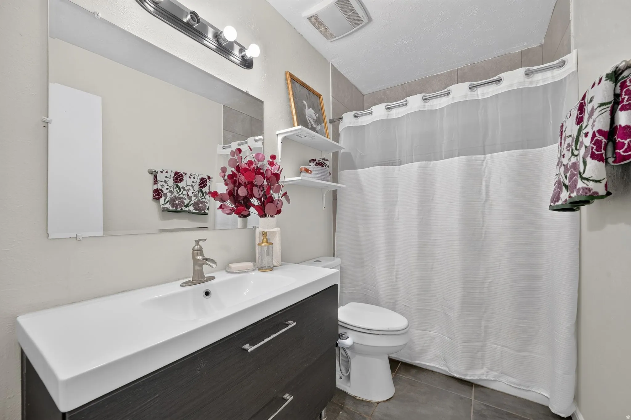 Integrated vanity with a single basin sink and brushed nickel faucet