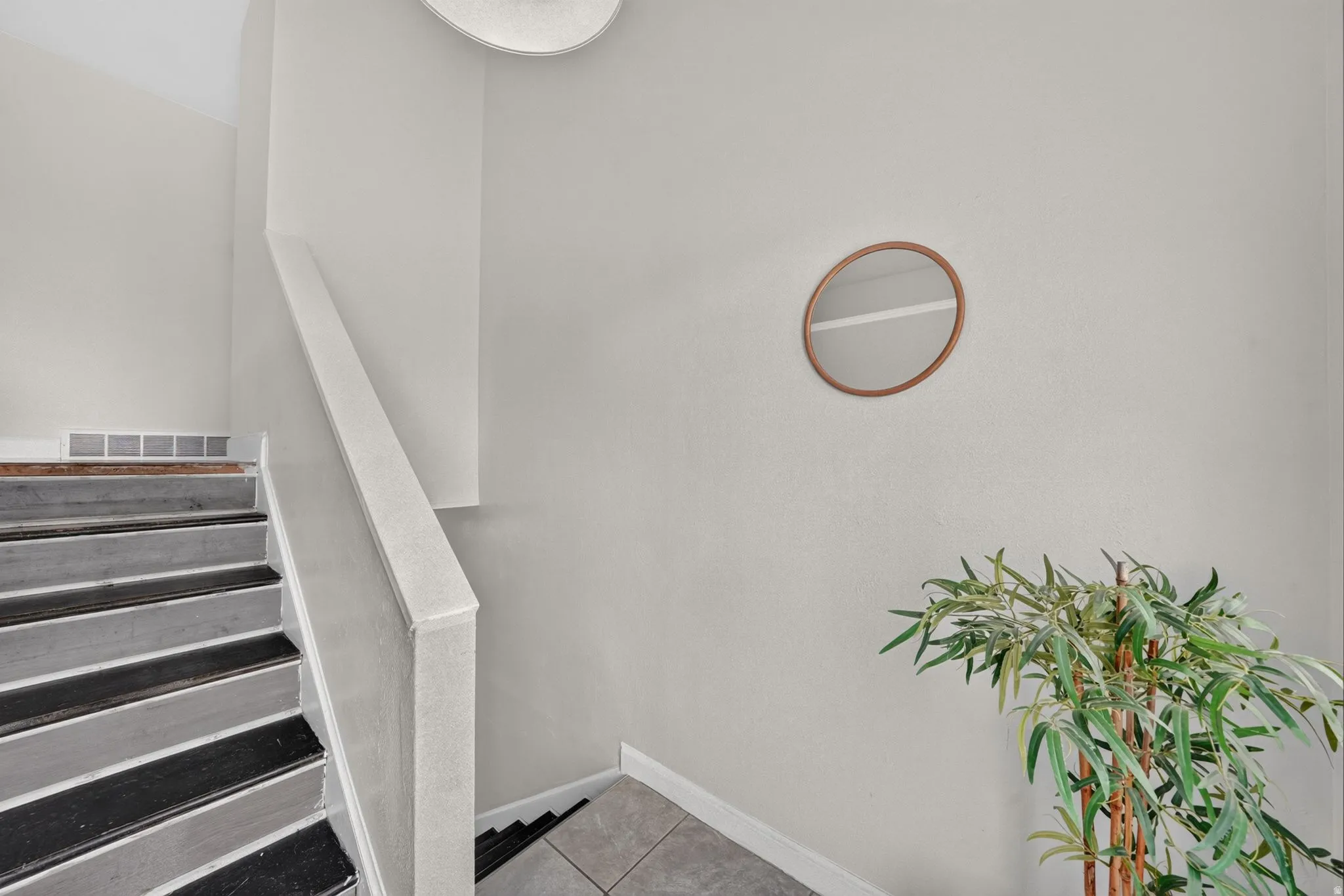 Staircase with painted treads and risers, featuring a white handrail