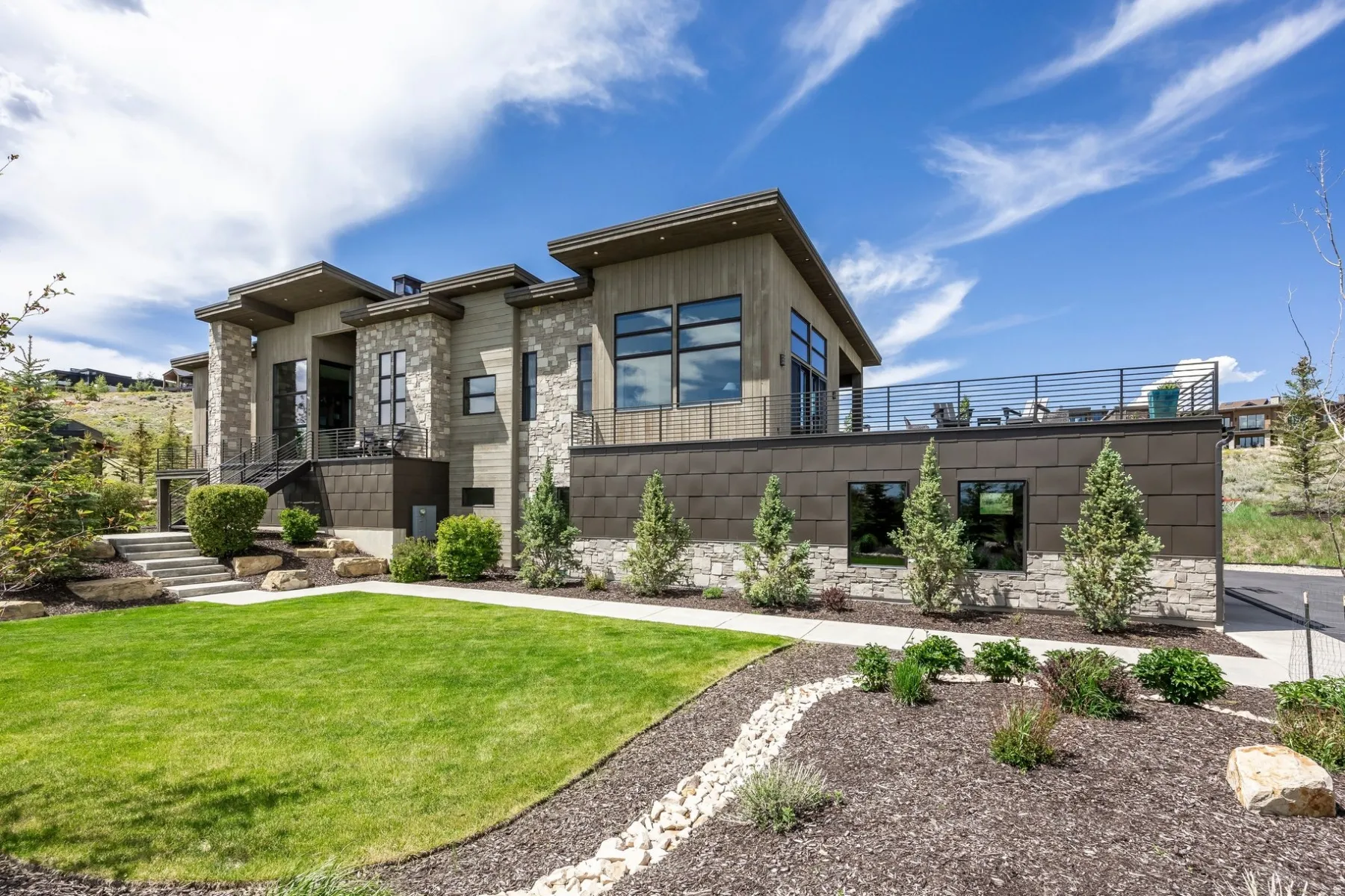 Modern architecture featuring a stone and wood-panel exterior