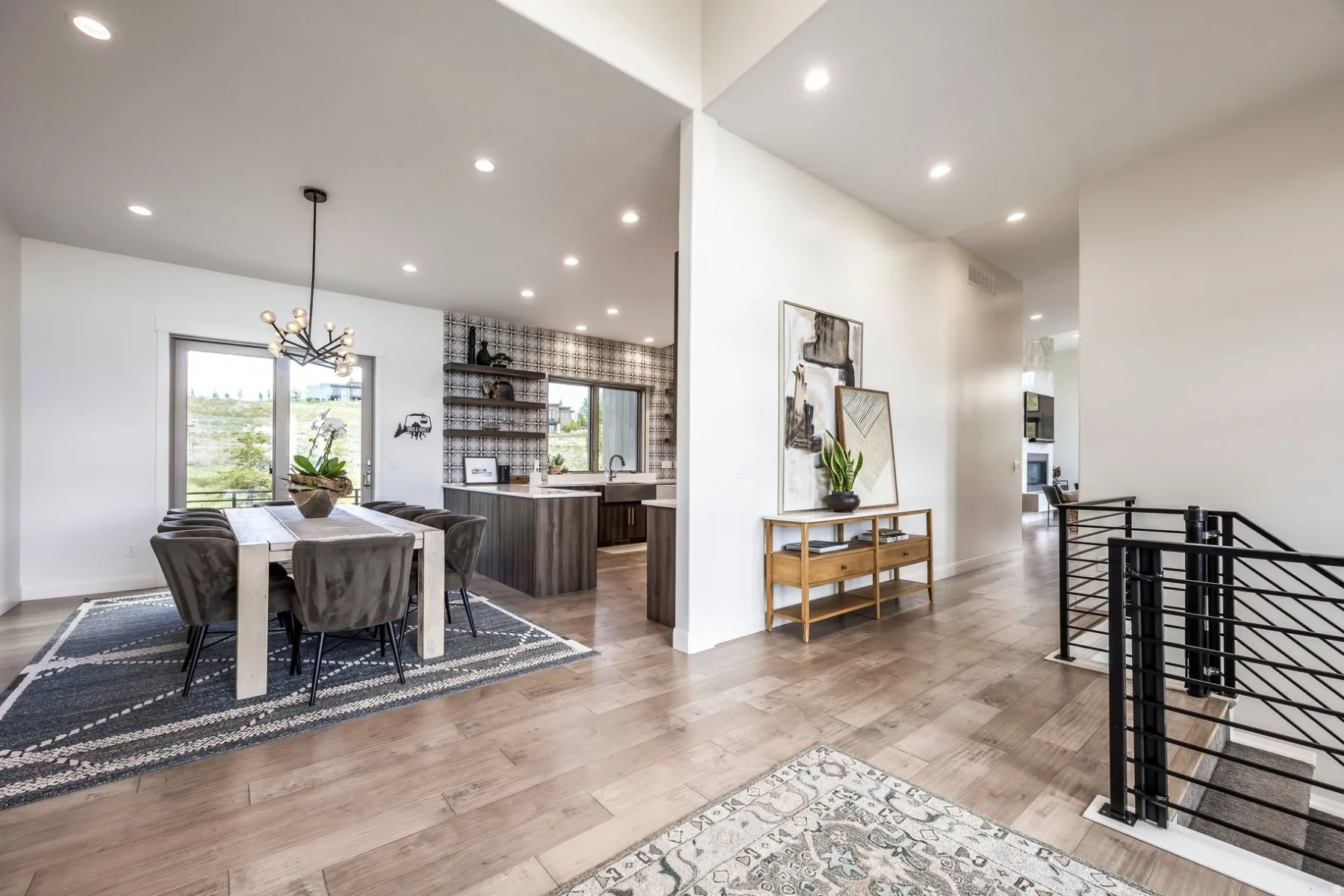 Open-concept layout with wood-finish flooring, recessed lighting, and a modern dining area