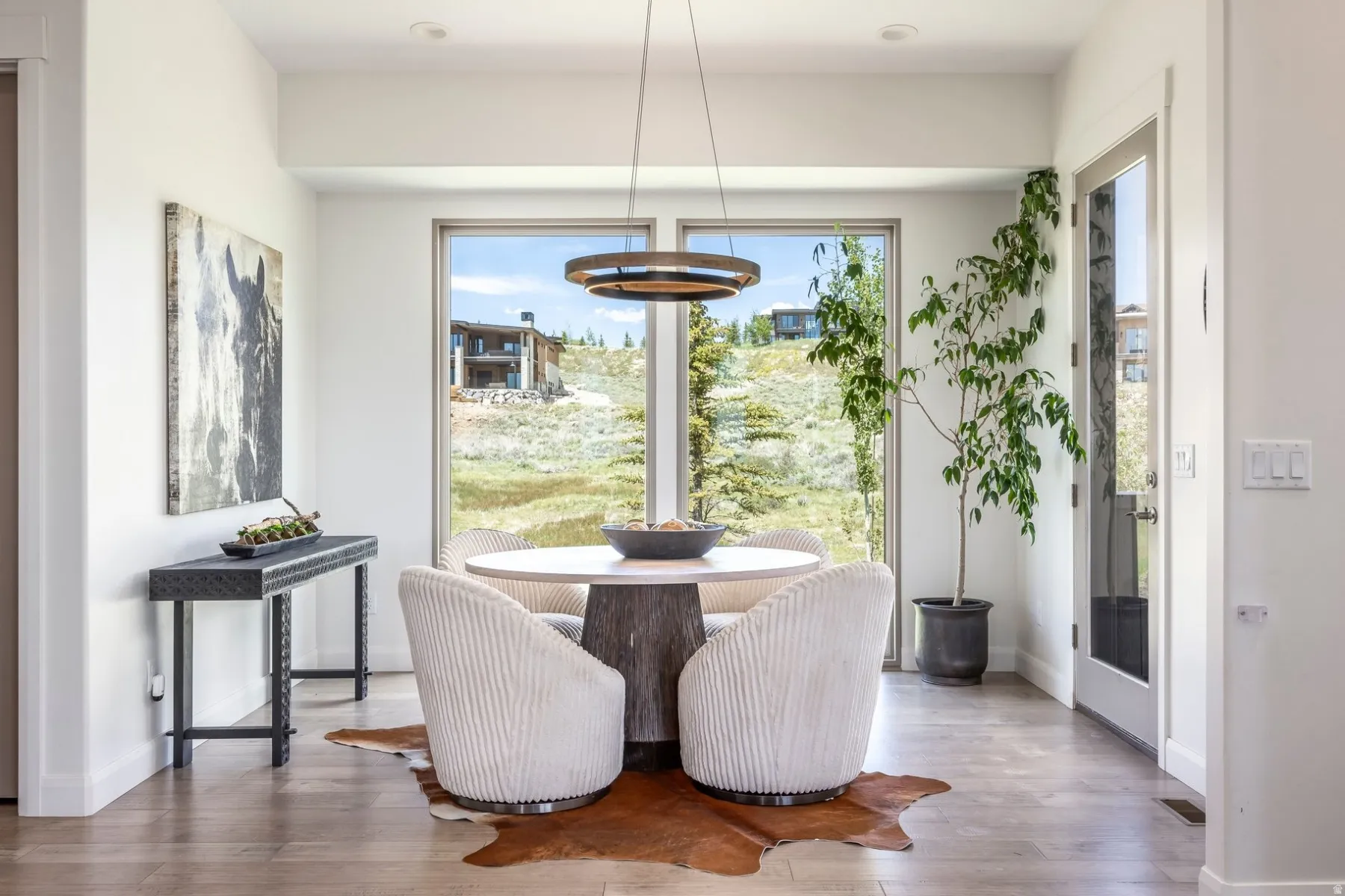 Hardwood flooring, recessed lighting, and a modern pendant light fixture