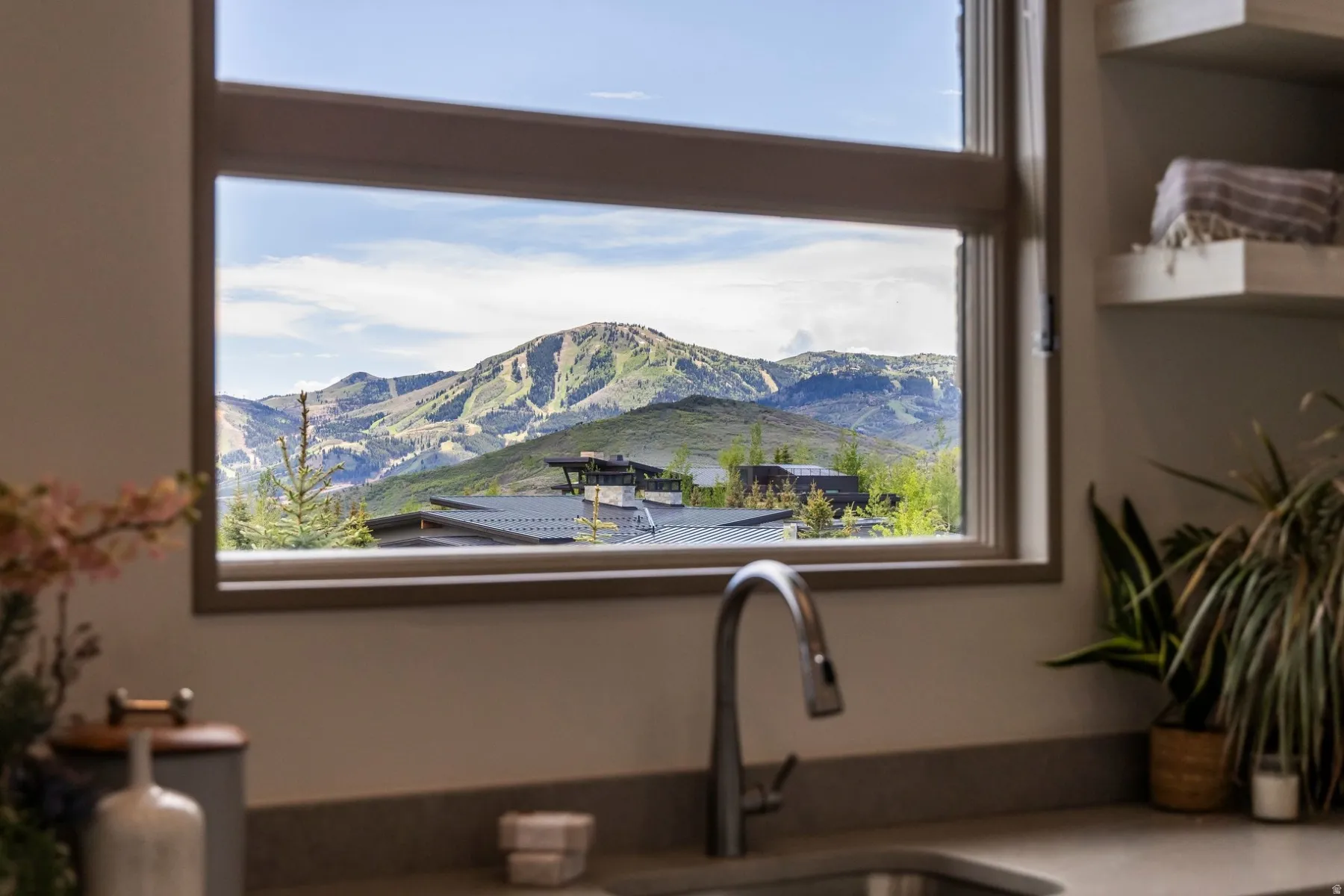 Large window framing a prominent mountain landscape