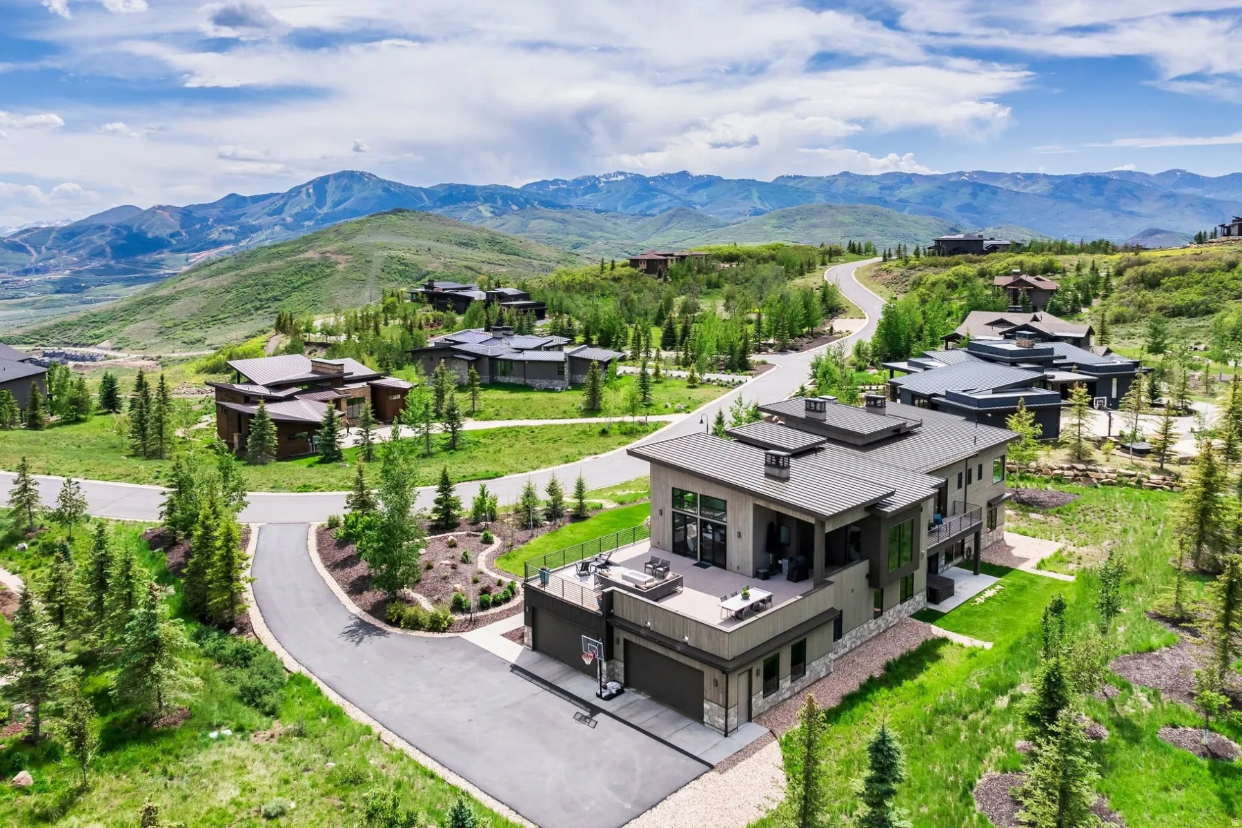 Contemporary architecture featuring a multi-level design, multiple outdoor terraces, and an integrated garage