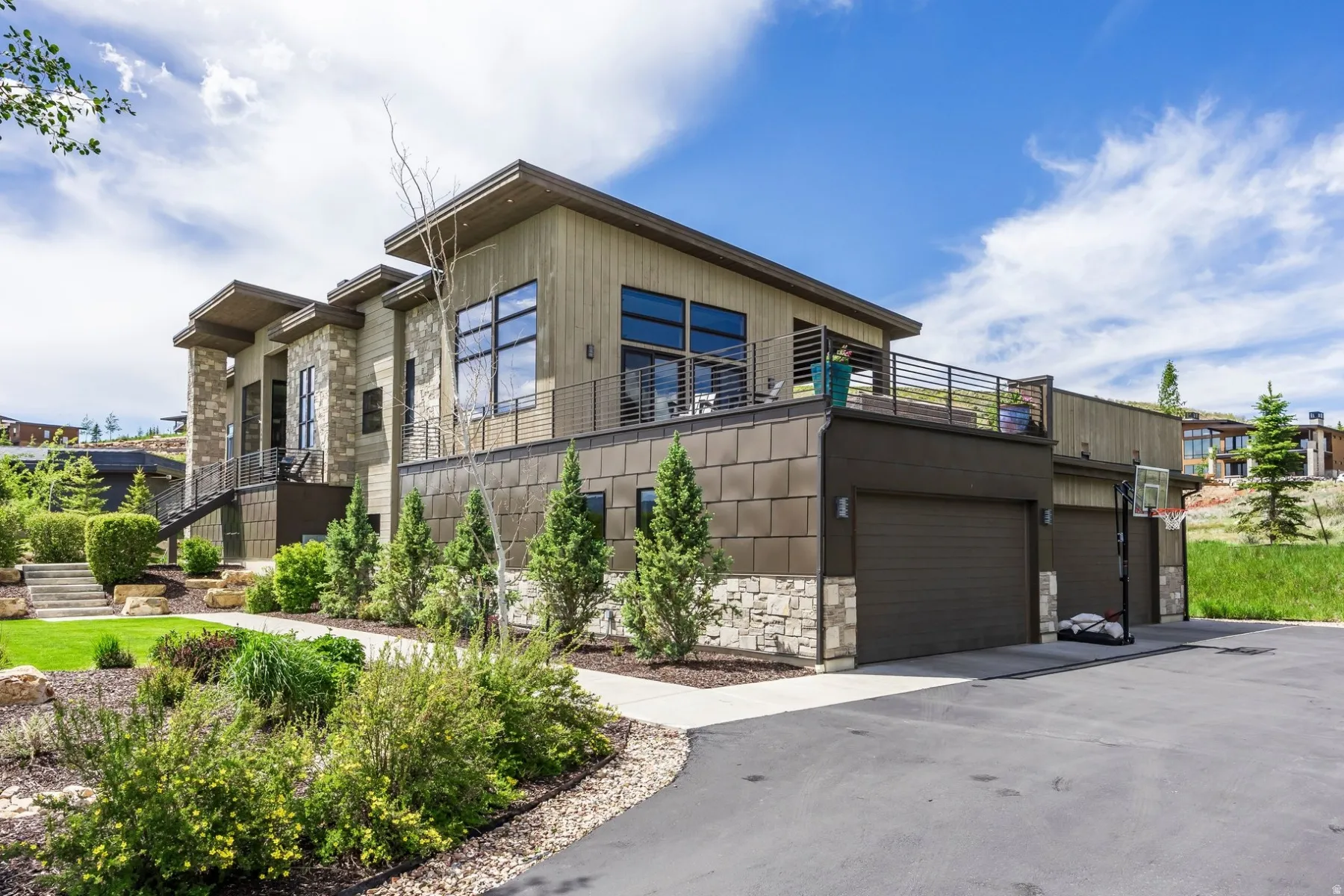 Contemporary exterior with stacked stone and wood-look siding