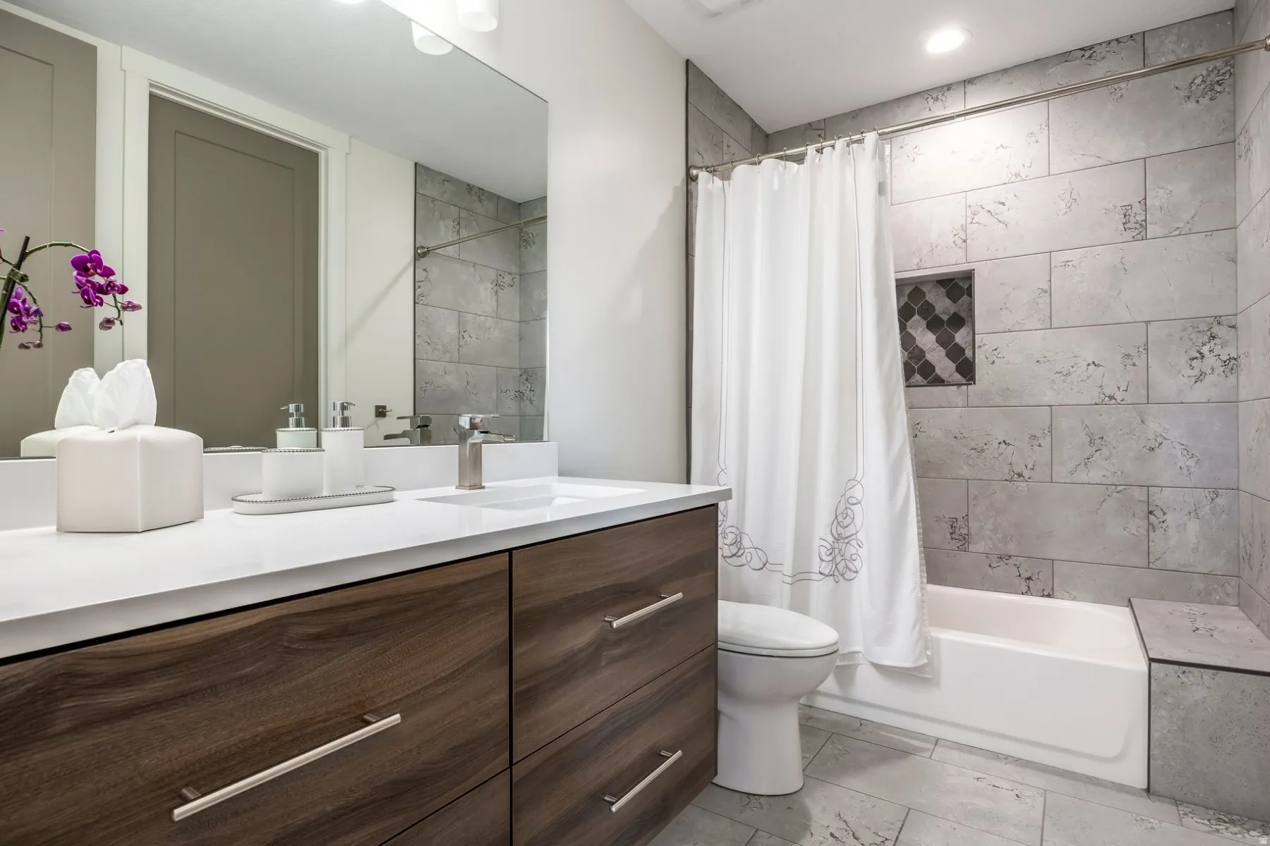 Modern vanity with wood-finish cabinetry and a white countertop