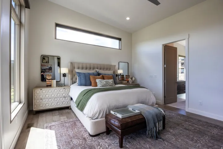 High ceilings with recessed lighting, wood-finish flooring, a contemporary ceiling fan, and a transom window