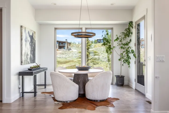 Hardwood flooring, recessed lighting, and a modern pendant light fixture