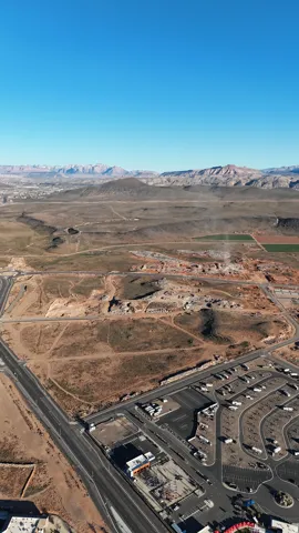 Expansive land parcel featuring existing infrastructure and distant mountain ranges