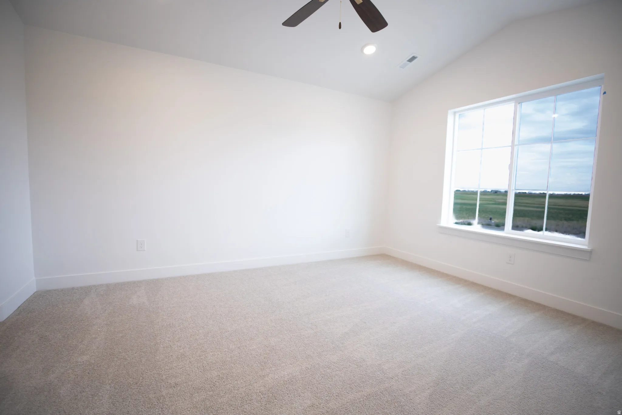 Primary bedroom featuring vaulted ceiling