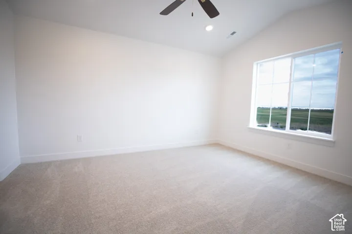 Primary bedroom featuring vaulted ceiling