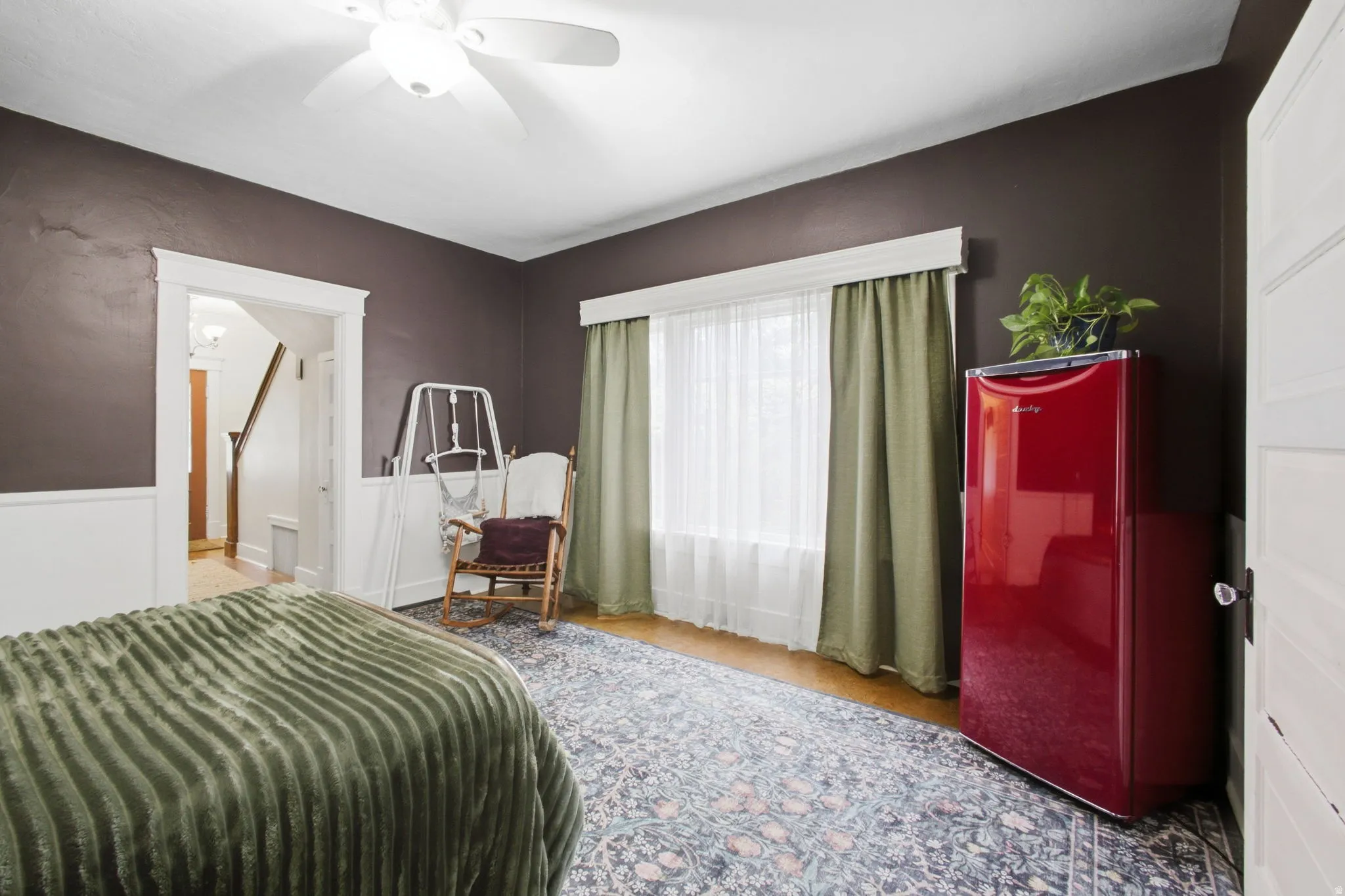 Hardwood flooring with a ceiling fan with integrated lighting.